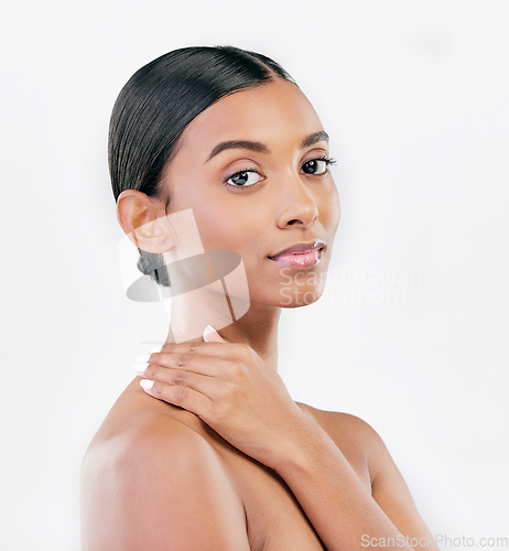 Image of Touch, beauty and face portrait of a woman with natural skin glow isolated on a white background. Dermatology, makeup and cosmetics of Indian female model for facial shine or self care in studio