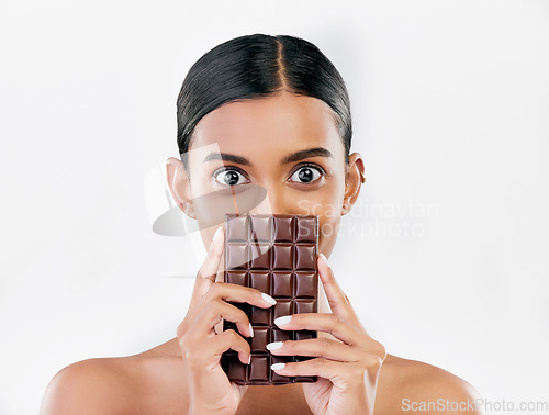 Image of Woman, portrait and chocolate in sweet diet or unhealthy eating against a white studio background. Female person or model with cocoa slab, block or bar in delicious treat, snack or diabetes on mockup