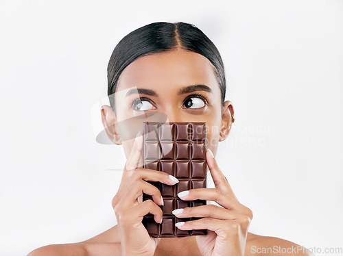 Image of Woman, thinking and chocolate in sweet diet or unhealthy eating against a white studio background. Female person or model with cocoa slab, block or bar in delicious treat, snack or diabetes on mockup