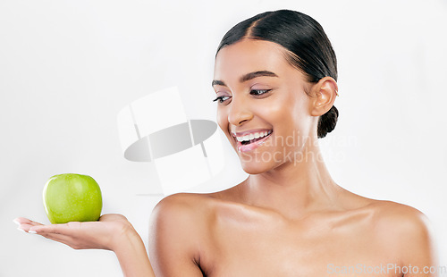 Image of Beauty, woman and apple in hands for skincare and natural glow isolated on white background. Dermatology, health and wellness of Indian person with facial, benefits and fruit for self care in studio