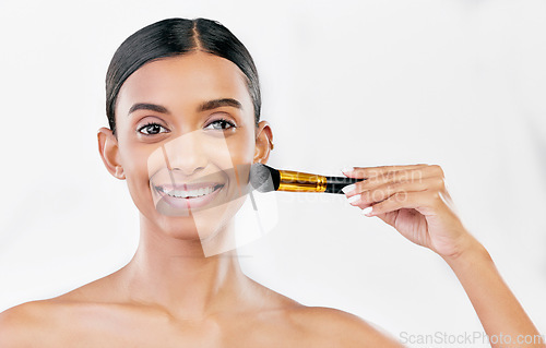 Image of Portrait, indian woman and brush for face makeup, cosmetics and aesthetic tools on white background, mockup space or studio. Happy female model brushing facial beauty product, foundation and skincare