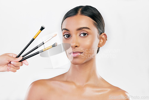 Image of Portrait, woman and makeup brush set for face, cosmetics or aesthetic tools on white background in studio. Indian female model, facial beauty product or collection of foundation, skincare or makeover