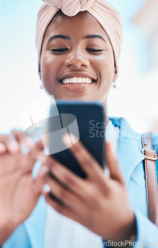 Image of Phone, business and black woman typing in city for social media, internet and online conversation. Travel, blue sky and face of happy female person on smartphone for chatting, website and networking