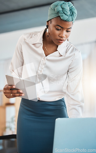 Image of Black woman, business and working on laptop, tablet and research online website in law firm. Attorney, lawyer and serious female employee search on digital technology, computer and legal data report