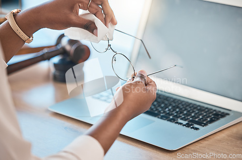 Image of Hands, glasses and cloth for cleaning in office for dust, dirt removal and clear vision with laptop mockup space in law firm. Eyewear, lens and person with fabric to wipe spectacles for maintenance.