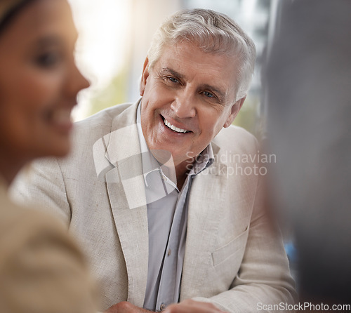 Image of Face, smile a senior business man in the boardroom with his team for a meeting in discussion of strategy. Happy, flare and a mature male CEO, manager or boss listening to an employee in the office