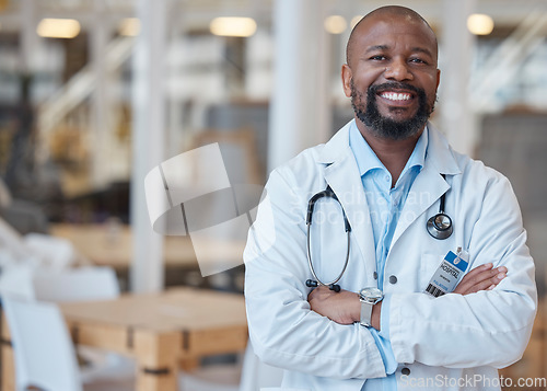 Image of Portrait, black man and happy doctor with arms crossed in hospital for healthcare. African medical professional, face and surgeon, person or confident employee from Nigeria with smile for wellness.