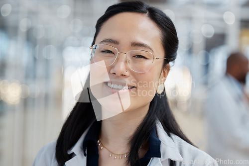 Image of Asian woman, face and happy doctor in hospital for healthcare, wellness and glasses. Medical professional, portrait and female surgeon, worker and employee with smile for health bokeh in clinic.