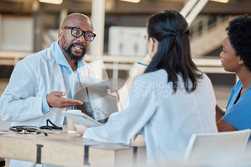 Image of Black man, doctors and meeting with xray in clinic for test results, research or healthcare review. Medical team, manager and group planning radiology assessment, x ray report and staff collaboration