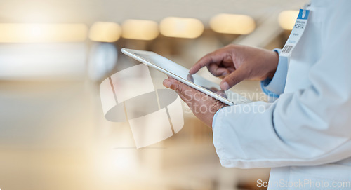 Image of Digital tablet, closeup and hands of a doctor browsing while doing medical research for a diagnosis. Healthcare, technology and professional male surgeon analyzing medicare data in hospital or clinic