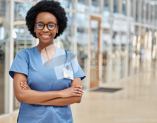 Image of Nurse, portrait and black woman with arms crossed, happy or smile in hospital. African medical professional, confidence and face of surgeon from Nigeria with glasses for healthcare service in clinic.