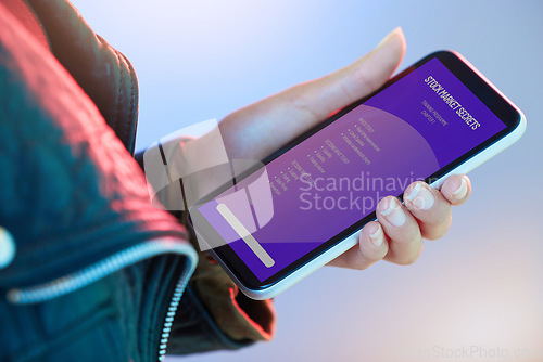 Image of Phone, stock market and information with the hand of a person in studio on a neon background for education. Mobile, data and trading with an adult trader reading a tutorial or instructions closeup