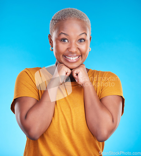 Image of Portrait, smile and black woman with hand on face with confidence in blue studio background. Beauty, cosmetic and girl with fashion or positive mindset for wellness or happiness and excited face.