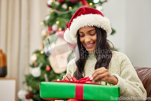 Image of Woman, Christmas and open present with smile, celebrate holiday with happiness and wrapped box with ribbon. Special event, female person at home with gift giving and package, festive and xmas