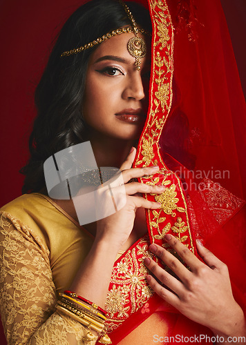 Image of Fashion, traditional and portrait of Indian woman with veil in ethnic clothes, jewellery and sari. Religion, beauty and female person on red background with culture accessory, cosmetics and makeup