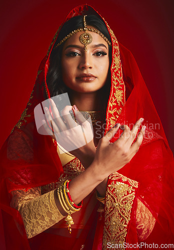 Image of Fashion, culture and portrait of Indian woman with hand sign in traditional clothes, jewellery and sari veil. Religion, beauty and female person on red background with accessory, cosmetics and makeup