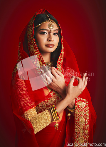 Image of Fashion, hand sign and portrait of Indian woman with veil in traditional clothes, jewellery and sari. Religion culture, beauty and female person on red background with accessory, cosmetics and makeup