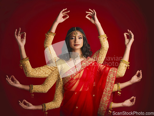 Image of Indian woman, portrait and goddess with many hands in studio background with sari and jewellery. Mudra, girl and beauty face with meditation with dress or movement with culture or spirituality.