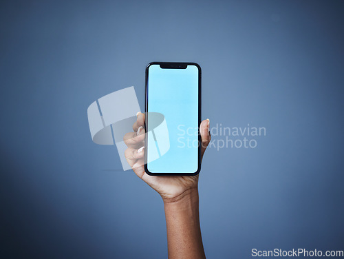 Image of Phone, mockup and woman hand in studio with space for plan, menu or information, contact or space on dark background. Blue screen, smartphone and person show text, product placement or social media