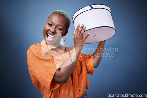 Image of Black woman, excited with gift box and celebration, special event and happiness isolated on blue background. African, female person with present and birthday, party and happy with surprise in studio