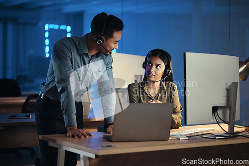 Image of Business people, call center and laptop at night in customer service or tech support at the office. Businessman and woman working late together for virtual assistant, consultant or agent at workplace