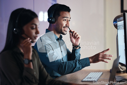 Image of Man, call center and headphones at night in customer service, support or telemarketing at the office. Happy male person, consultant or agent with headset on computer in online advice at the workplace