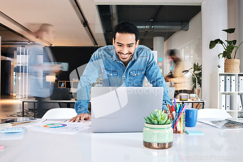 Image of Laptop, happy and asian business man in office positive results, report or feedback, reading or email. Smile, good news and male designer online for creative, inspiration or idea in coworking space