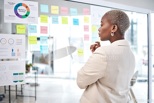 Image of Black woman, thinking and glass board for project management, marketing or planning at office. African female person, manager or employee checking project plan, tasks or statistics at the workplace