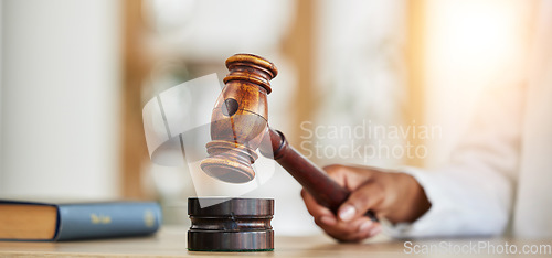 Image of Closeup, lawyer and gavel of judge in office of trial, attention and meeting for justice in courtroom, law firm or table. Hammer, legal tool and hands of person for decision, constitution or attorney