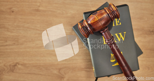 Image of Background, law books and gavel on table at mockup space of judge, justice or lawyer in courtroom. Overhead, hammer and research knowledge of legal system, constitution and truth, litigation or trial