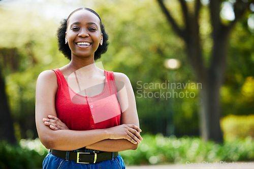 Image of Portrait, outdoor and black woman with arms crossed, casual outfit or confidence with freedom. Face, female person or girl with happiness, park or cheerful with streetwear, Nigerian or trendy clothes