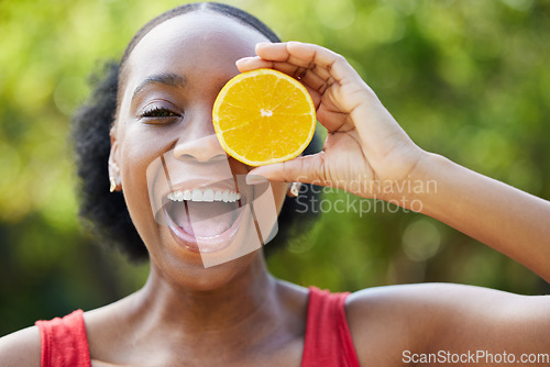 Image of Happy black woman, face and orange for vitamin C, natural nutrition or citrus diet in nature outdoors. Portrait of African female person smile with organic fruit in healthy eating or wellness in park