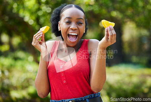 Image of Happy black woman, orange slice and natural vitamin C for nutrition or citrus diet in nature outdoors. Portrait of African female person with organic fruit, food or fiber for healthy wellness in park