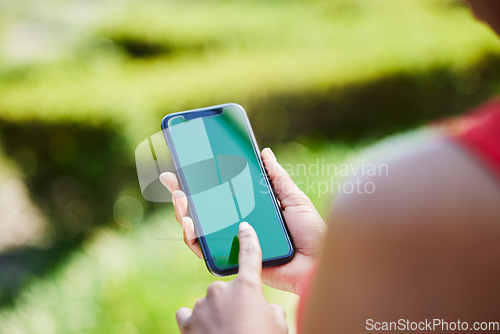 Image of Woman, hands and phone mockup for advertising, mobile app or communication on green screen in nature. Female person with smartphone display or chromakey for advertisement or marketing in the outdoors