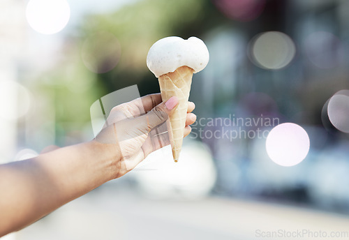 Image of Hands, person and ice cream cone in city for dessert, cool snack and sweet food to enjoy outdoor. Closeup, scoop and frozen vanilla gelato in summer, travel and sunshine of urban town, street or trip