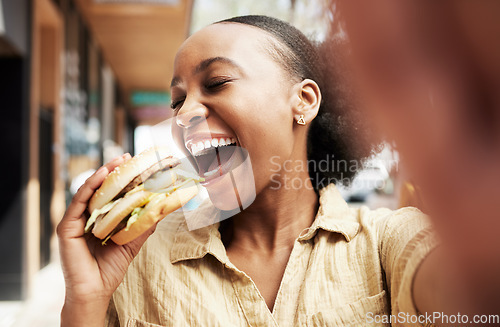 Image of Burger, eating and woman in selfie, city and restaurant outdoor promotion, social media and live streaming review. Fast food, hungry and african person, customer or influencer with lunch photography