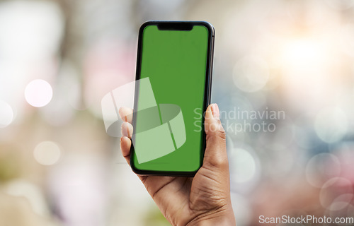 Image of Smartphone, green screen and person hands in city for social media, advertising and website ui or ux design mockup. Mobile app, technology and people with phone space for outdoor or urban bokeh