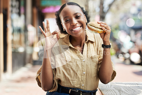 Image of Burger, okay sign and portrait of woman in city, outdoor restaurant and happy customer experience or services. Fast food, like and excited african person with lunch review, excellence and yes emoji