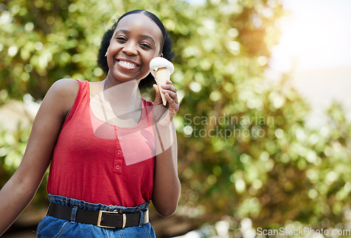 Image of Happy, portrait and a black woman with ice cream in nature for a summer dessert or treat. Smile, mockup and an African girl eating a cold and frozen cone while hungry in a park or garden in spring