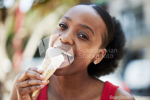Image of Portrait, happy black woman and eating ice cream cone for frozen dessert, cool snack and sweet food outdoor in summer. Face, smile and young female person lick scoop of melting vanilla gelato in city
