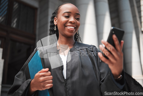 Image of Judge, court or lawyer with phone to contact a client, communication or legal services and advice on mobile app online. Smile, black woman and smartphone for research, information or consulting law