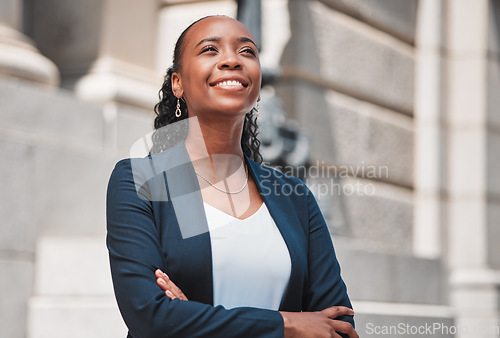 Image of Arms crossed, happy black woman or lawyer thinking with smile or confidence working in a law firm. Court, empowerment or proud African attorney with leadership, ideas or vision for legal agency