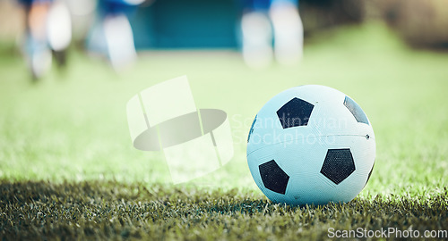 Image of Field, sports and a football on the grass for a game, goal or training in summer. Fitness, playing and gear for soccer, competition or athlete exercise on the ground for a match or cardio in nature