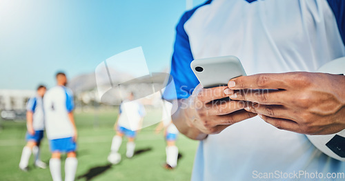 Image of Football, field, phone and man hands for competition, training or fitness news, social media chat and blog. Soccer player or person typing on mobile app for sports information, health or goal check