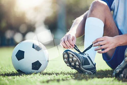 Image of Ball, man and soccer player tie shoes for training, fitness games and performance on field. Closeup, football athlete and lace sneakers on feet, grass pitch and sports competition on stadium ground