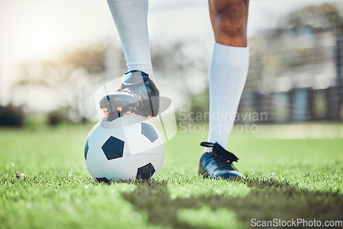 Image of Legs, sports or man with a soccer ball on a field for exercise, fitness and training for a competition outdoors. Football club, ready or boots of player in a game event or match in stadium on grass