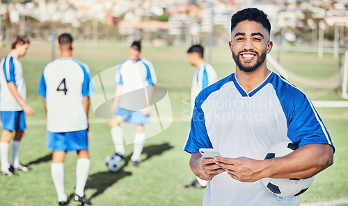 Image of Football player, phone and portrait at game on a field for sports and fitness app. Happy male soccer or athlete person outdoor for challenge, competition or motivation with online communication