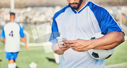 Image of Soccer field, phone and man hands for competition, training or fitness news, social media chat and blog. Football player or person typing on mobile app for sports information, health or goals check