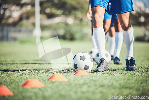 Image of Feet, soccer player and ball with training cone on a field for sports game and fitness. Legs or shoes of male soccer or athlete person outdoor for agility, performance or workout on a grass pitch