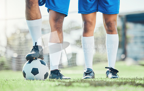 Image of Legs, soccer and ball with a team ready for kickoff on a sports field during a competitive game closeup. Football, fitness and teamwork on grass with players standing on grass to start of a match